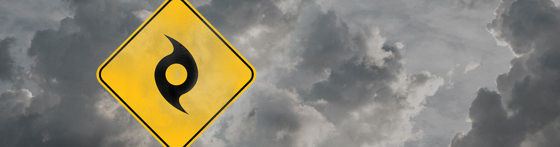 A warning hurricane sign with dark clouds looming.