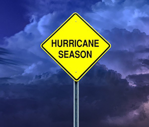 A sign that says Hurricane Season. A dark, stormy beach is in the background.